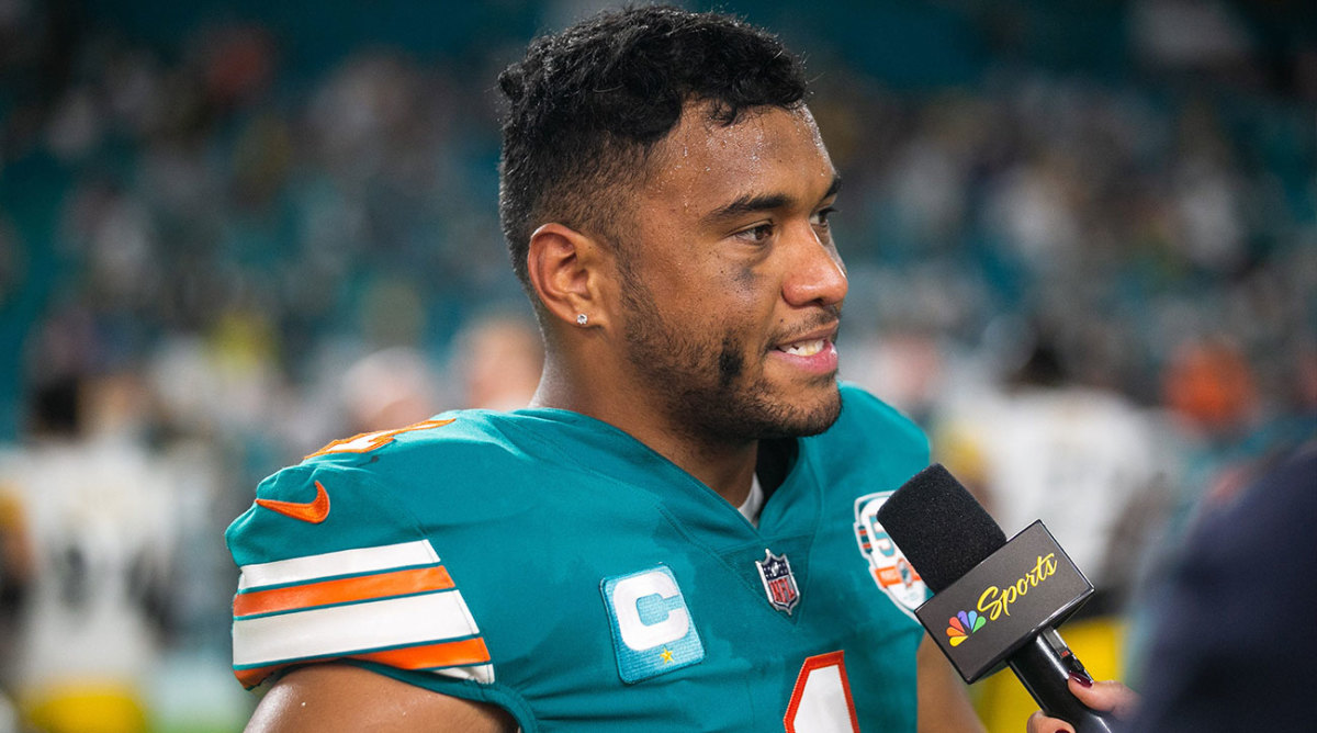 Tua Tagovailoa answers a question in a TV interview following a Dolphins win.